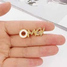 OMG brooch